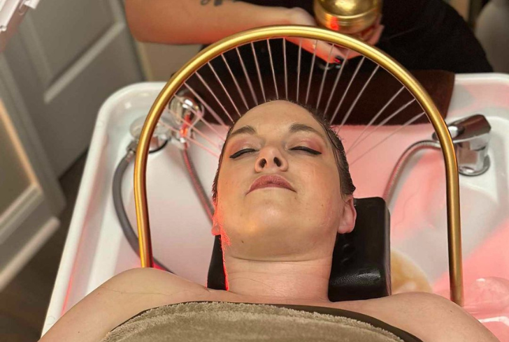 Woman taking head spa treatment